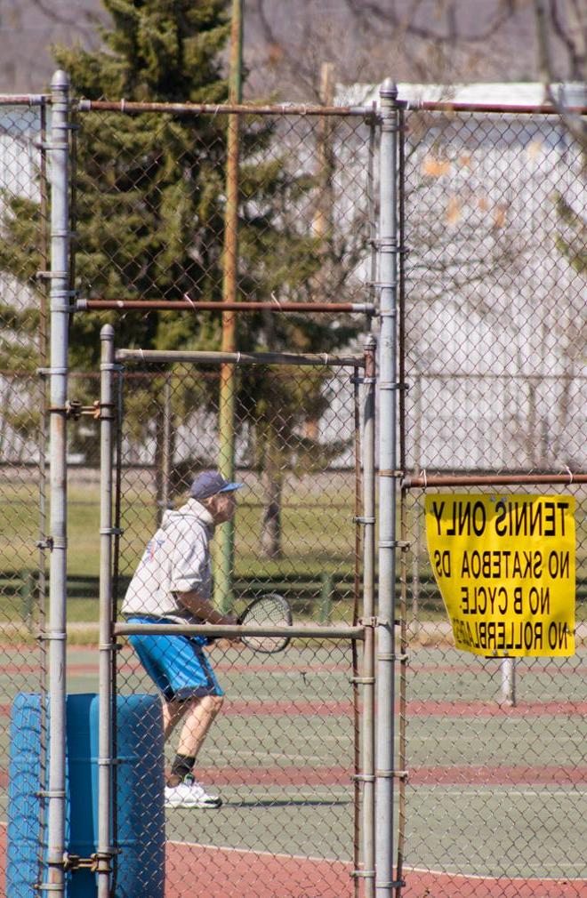 Man playing tennis.
