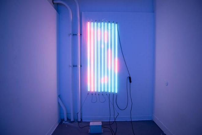 Nine clear tubes pumped neon mercury each five feet tall. Shifting from red to a light blue light. Hung vertically on a white wall.  每根管子之间间隔三英寸，跨度为两英尺. 